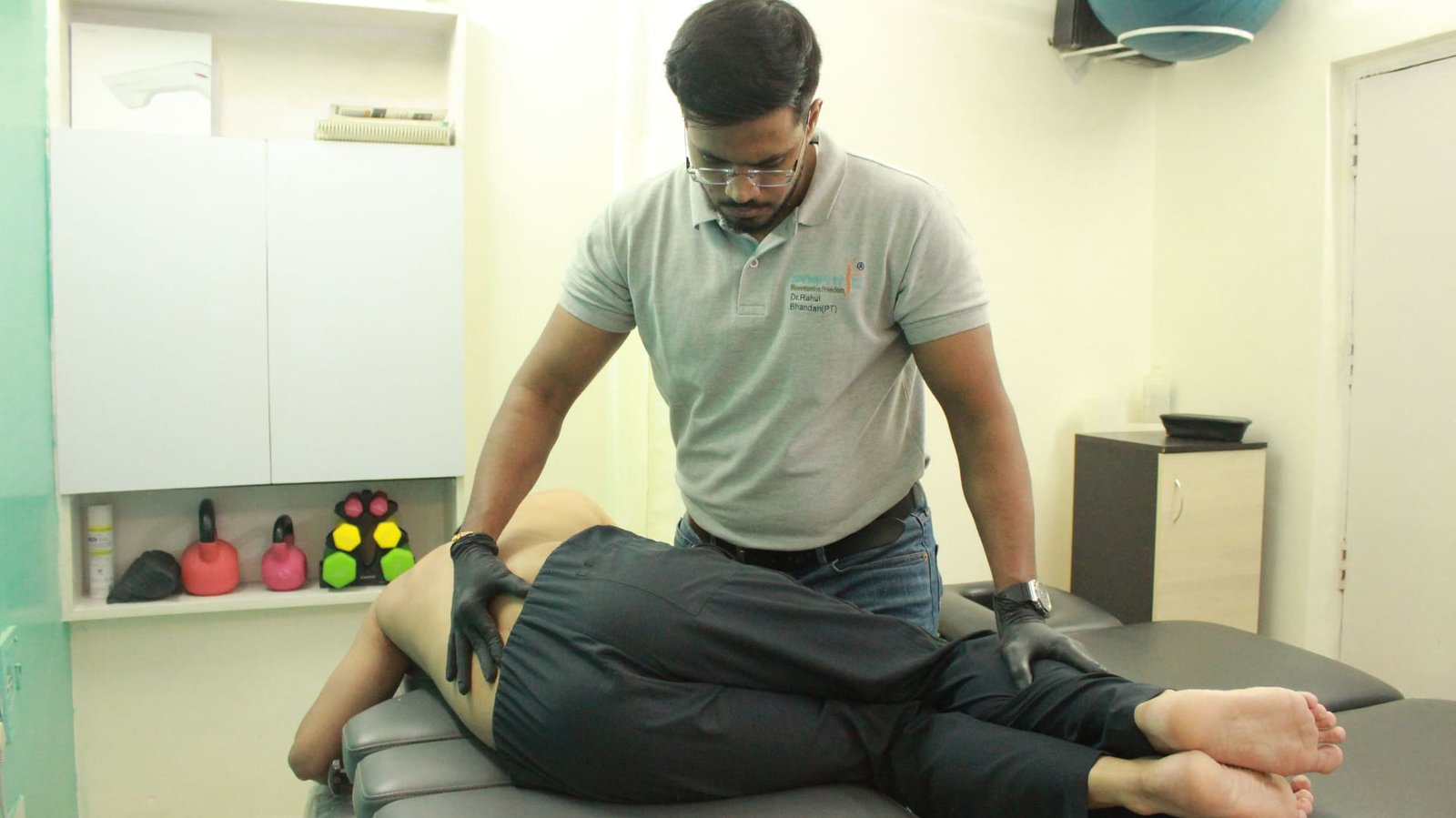 Physiotherapist performing manual lumbar spine therapy on a patient at Symphysio, Sarita Vihar