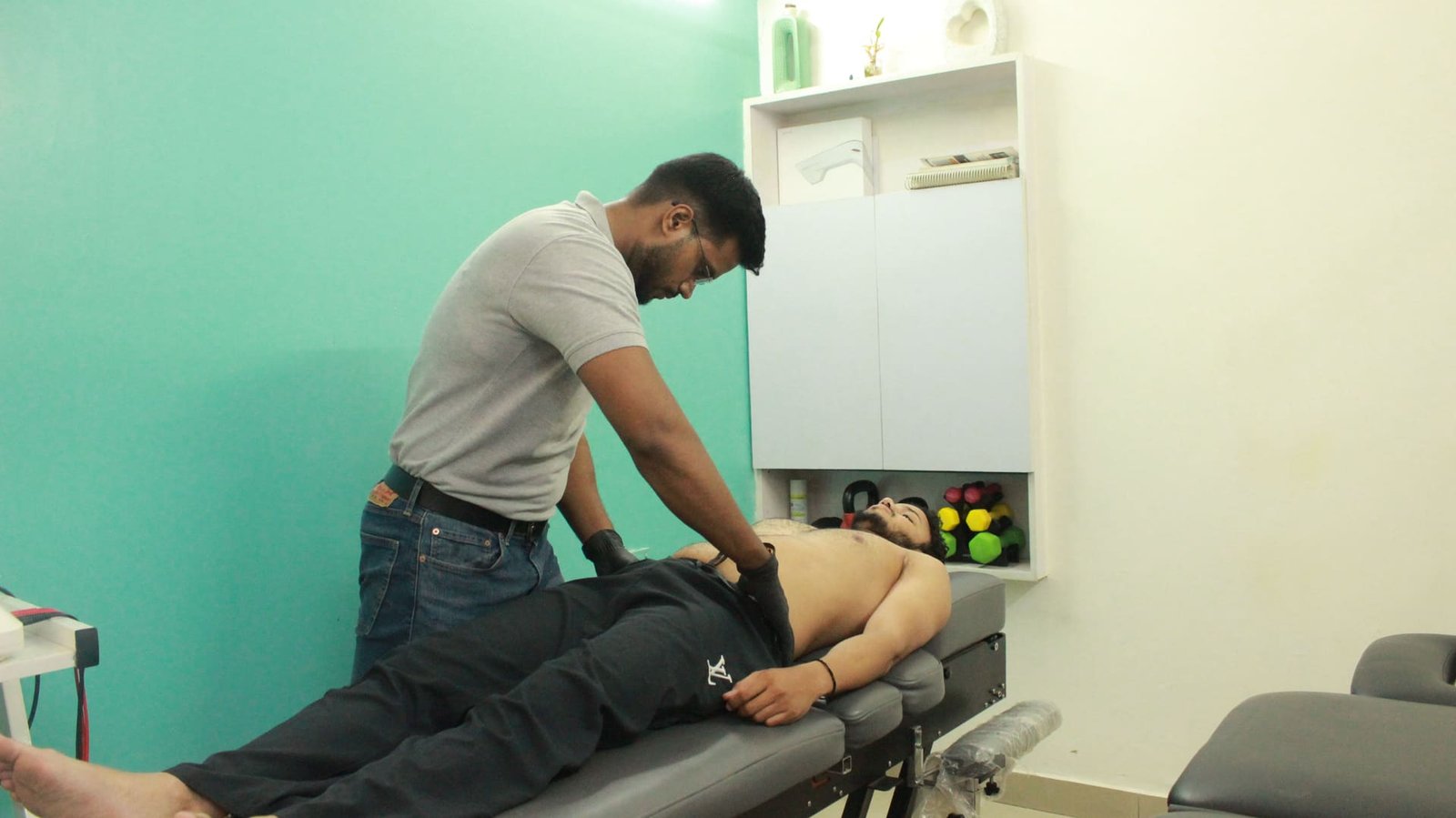 Physiotherapist performing gentle visceral manipulation therapy on a patient at Symphysio, Sarita Vihar